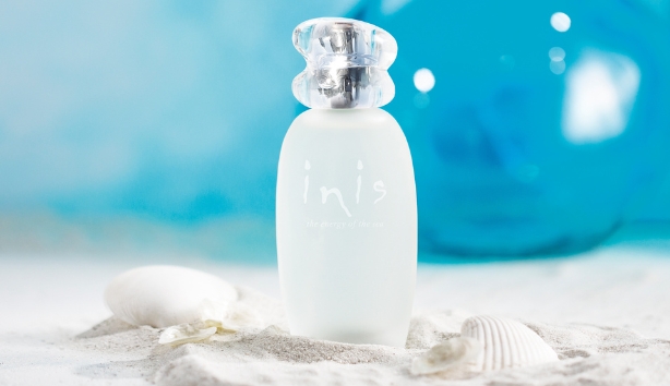 Lifestyle images of Inis perfume bottle on the beach. Enjoying the sparkling fresh scent of inis at Maybugs