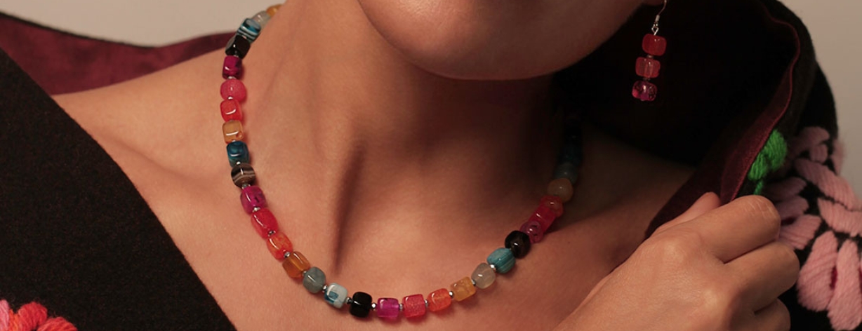 Lifestyle images of Carries Elspeth new collection 2024, rainbow agate cubes necklace on a model