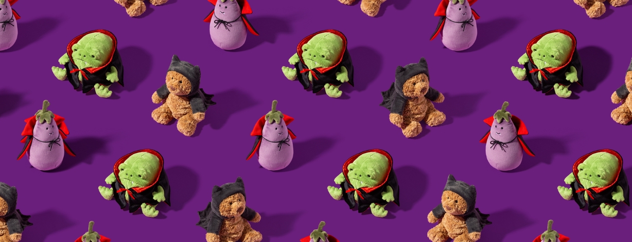 Lifestyle shot of Jellycat Halloween collection 2024 on purple background, showing the Aubergine and Ricky Vampier and Bartholomew bat bear