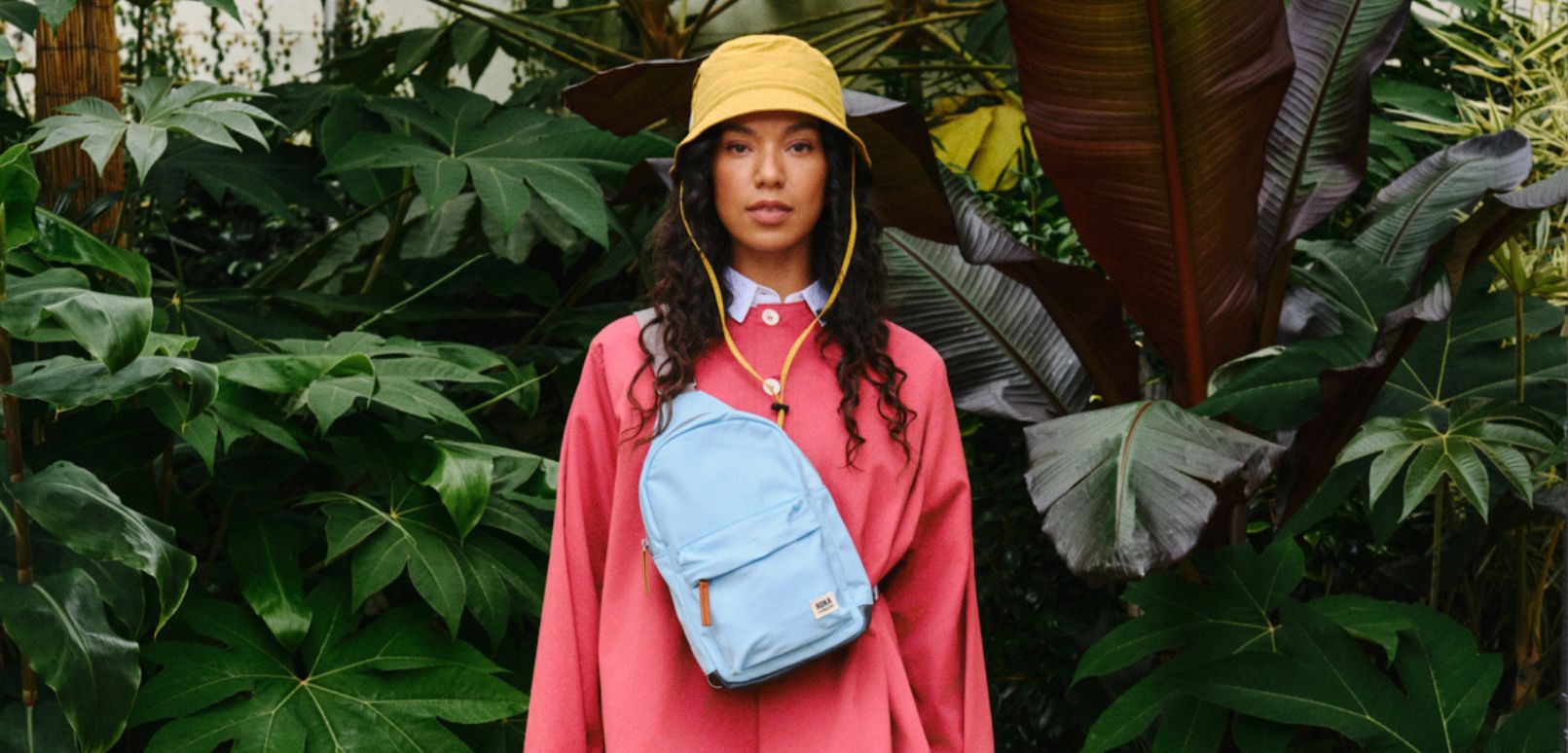Lifestyle image of model wearing a Roka Oasis collection bag in canal blue, part of the 2024 collection